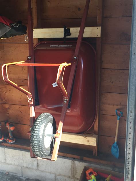 How To Hang Wheelbarrow On Wall Keep Your Wheelbarrow in Track with this DIY Rack — Family Handyman